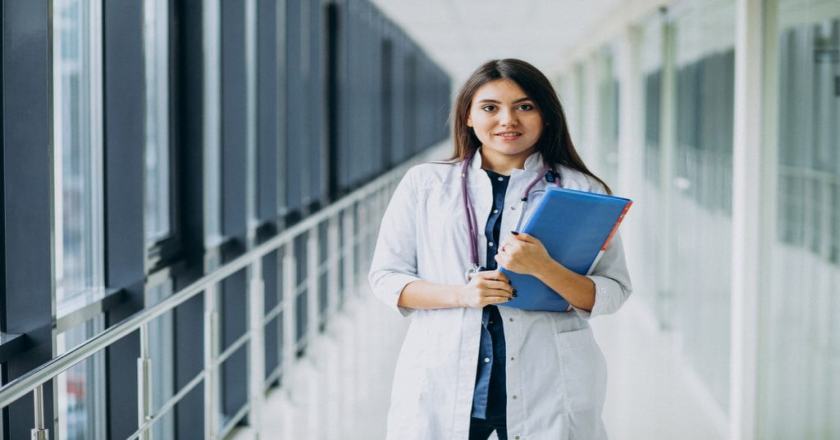 attractive-female-doctor-standing-with-documents-hospital-1-